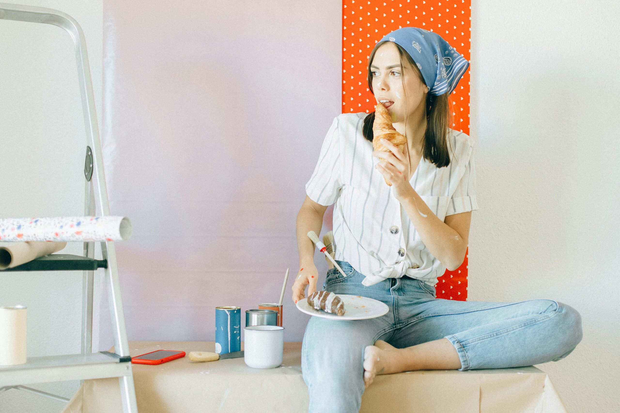 Painting services - Woman in White Shirt and Blue Denim Jeans Sitting on White Plastic Seat